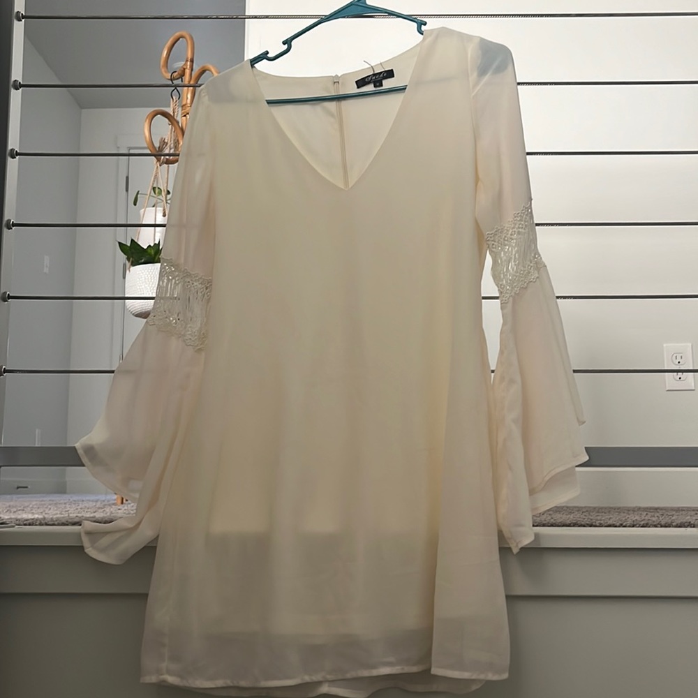 Its a white short dress with long sleeves
